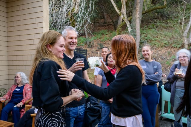 Sarah greeted with a hug in the courtyard