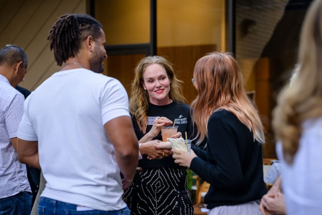 Sarah laughing with guests outside the studio