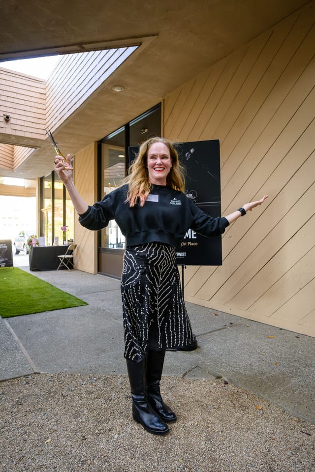 Sarah raising the scissors after the ribbon cutting