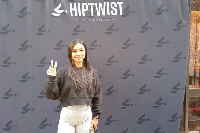 A guest flashing a peace sign at the Hiptwist photo booth