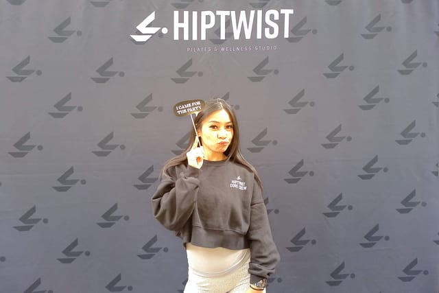 A guest holding an &ldquo;I came for the party&rdquo; sign