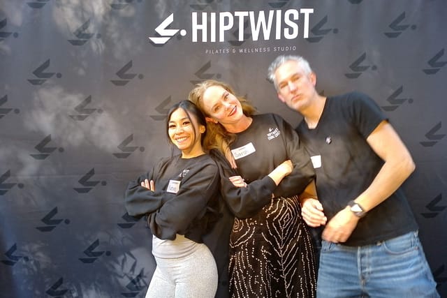 Sarah with two guests, arms linked at the photo booth
