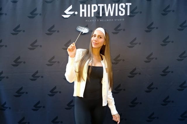 A guest posing with a photo booth prop