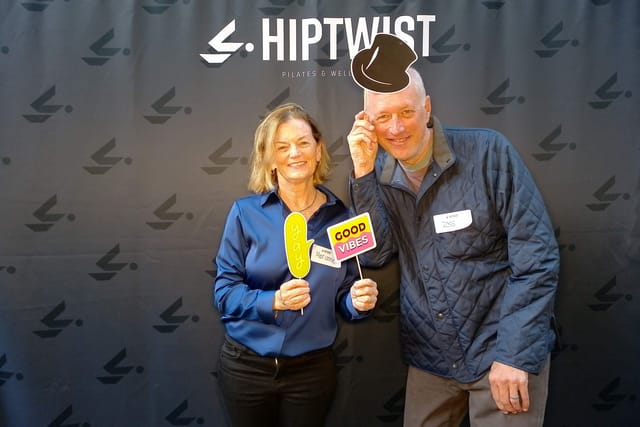 A couple with a top hat, a &ldquo;yay&rdquo; bubble and a &ldquo;Good Vibes&rdquo; sign