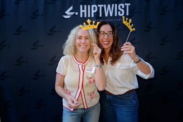 Two friends holding up crowns