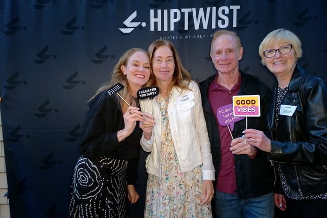 Sarah with three guests and a handful of party signs