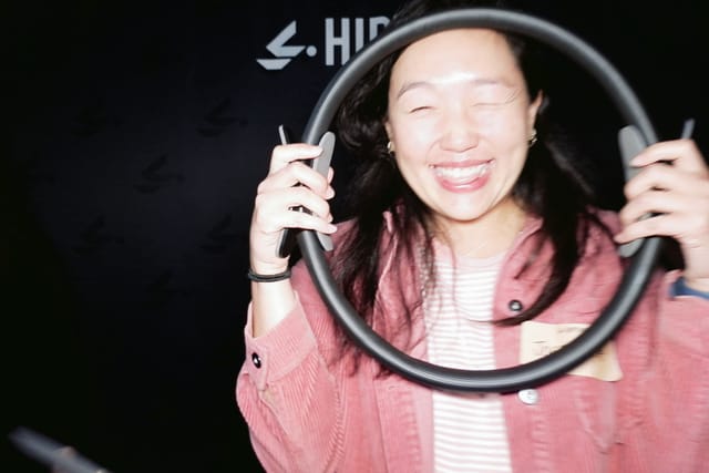 A guest laughing through a Pilates ring