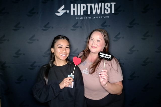 Two guests with a heart and an &ldquo;I came for the party&rdquo; sign