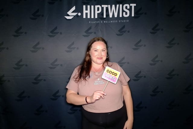 A guest with a &ldquo;Good Vibes&rdquo; sign