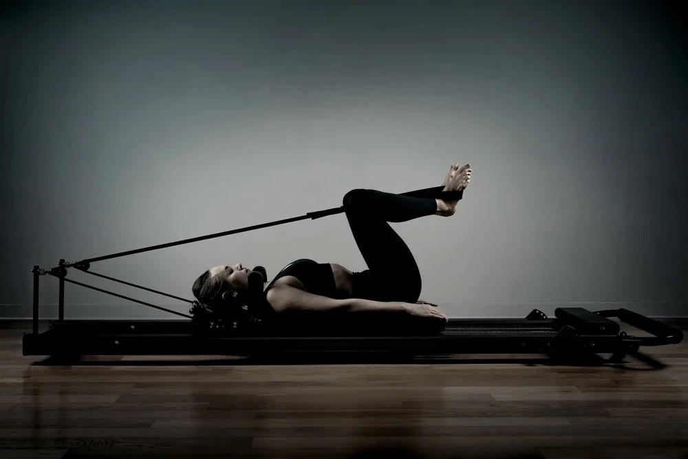 Pilates instructor on reformer