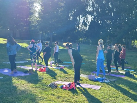 Group mat Pilates class at golden hour, Beresford Park, San Mateo - Hiptwist Happy Hour pop-up